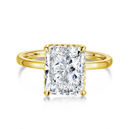 A radiant cut diamond ring with a silver band and a yellow gold setting.