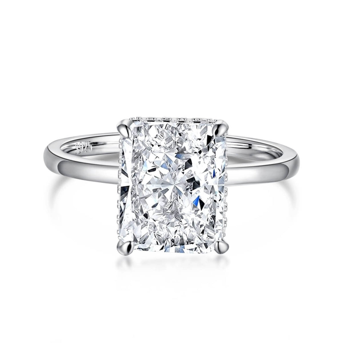 A radiant cut diamond ring with a silver band and a white gold setting.