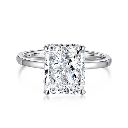 A radiant cut diamond ring with a silver band and a white gold setting.