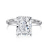 A radiant cut diamond ring with a silver band and a white gold setting.