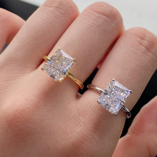 Gold and silver ring with square-cut diamonds on a hand
