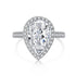 A pear-cut clear cubic zirconia ring with a halo of smaller clear stones around it, set on a white gold band.